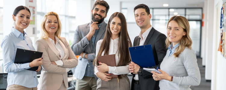 A group of employees smile in office